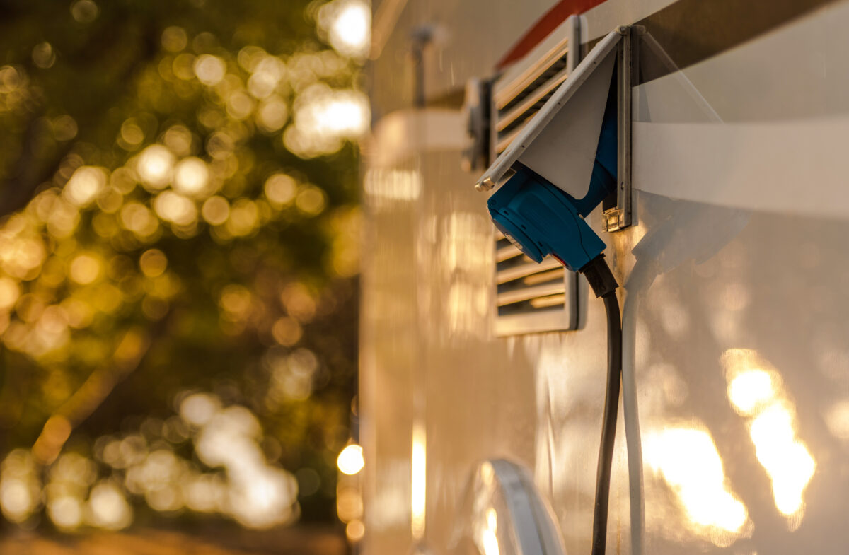 RV electrical power cord hooked up to the side of the RV